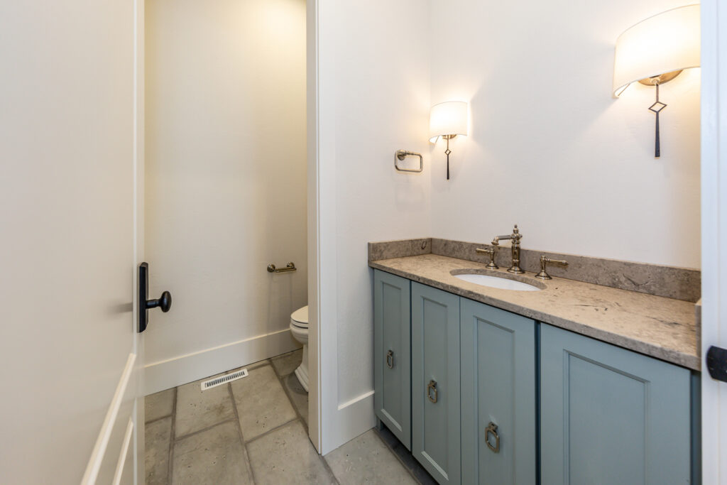 Picture of a bathroom with gray cabinets.